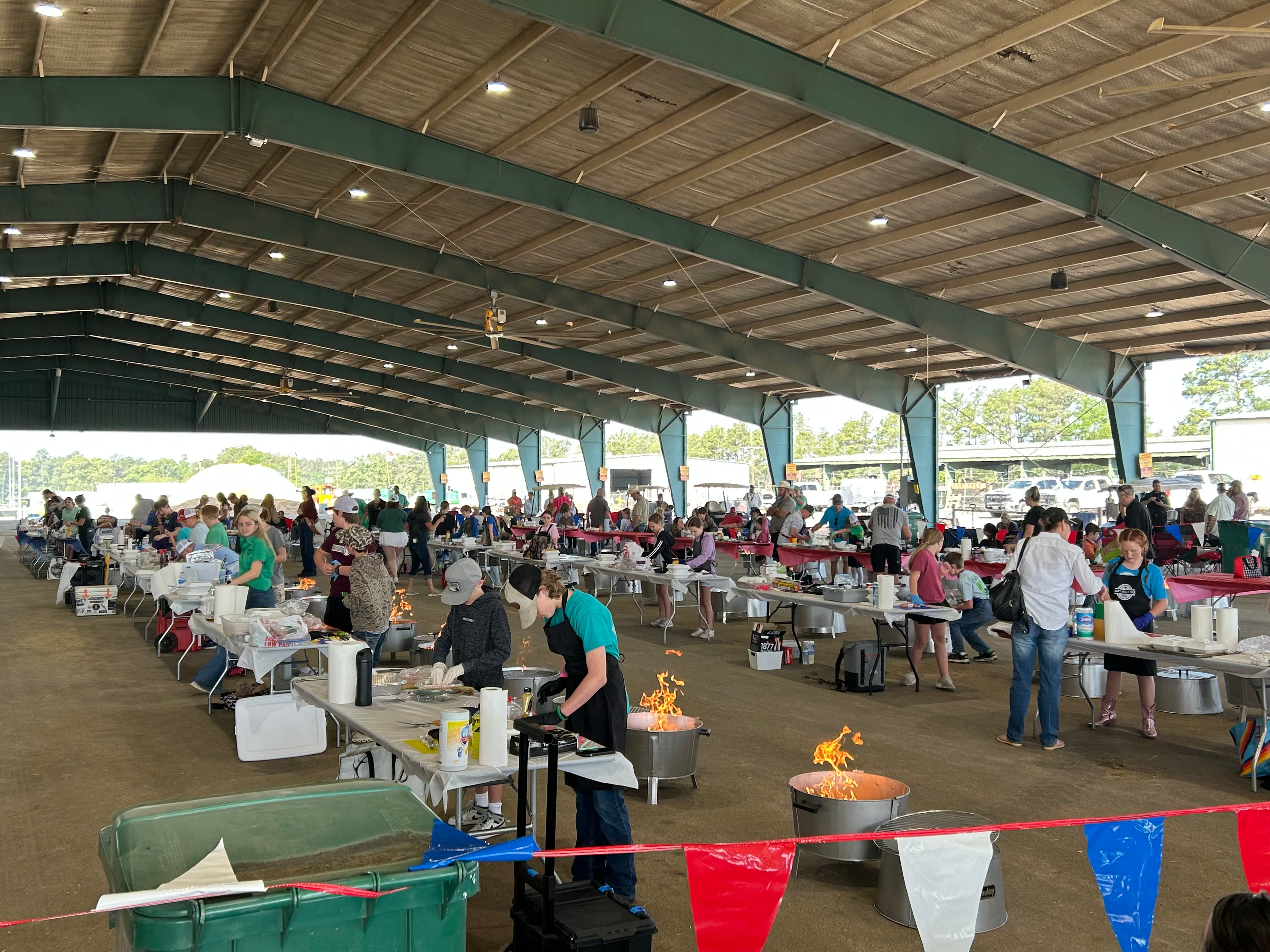 An Old Smokey cooking competition held under a pavilion with many tables